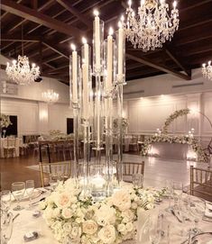 an elegant centerpiece with white flowers and candles