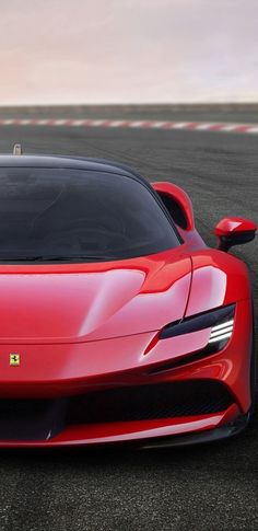 a red sports car driving on a race track