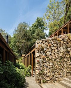 there is a stone wall on the side of this house