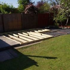 an outdoor area with wooden steps in the grass