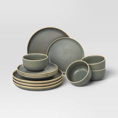 a set of grey dishes and cups