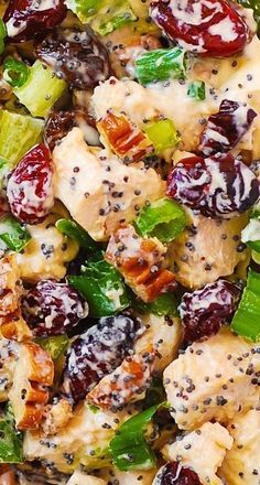 a salad with chicken, broccoli and cranberries is shown close up