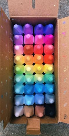 a box filled with lots of different colored candles