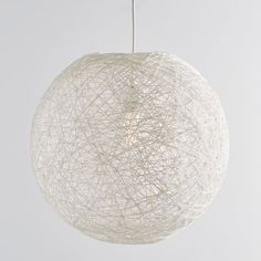 a white ball shaped light hanging from a ceiling