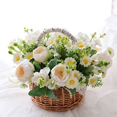 a basket filled with white and yellow flowers