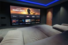 a large screen tv mounted to the side of a wall in a home theater room