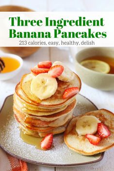 pancakes with sliced bananas and strawberries on a plate