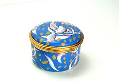 a blue and gold decorated box on a white surface