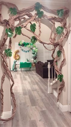 a living room decorated with paper vines and balloons