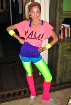 a woman wearing neon colored tights and leggings posing for the camera with her hands on her hips