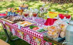 a picnic table with food and drinks on it