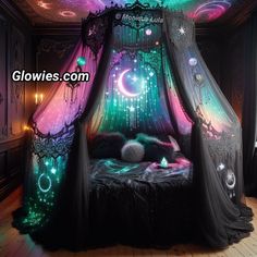 the canopy bed is decorated with colorful lights