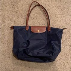 Longchamp 'Large Le Pliage' Tote, New Navy Color, Originally Purchased From Nordstrom. Gently Used, Minor Scuffing On Bottom And Back (Pictured). 12 ¼"W X 11 ¾"H X 7 ½"D. 9" Strap Drop. Navy Blue Longchamp, Navy Longchamp, Blue Longchamp, Longchamp Large Le Pliage Tote, Longchamp Medium, Longchamp Le Pliage Large, Longchamp Tote, Longchamp Bags, Nylon Tote