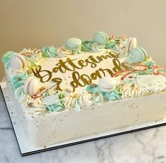 there is a cake that has been decorated with seashells and the words batten's island on it