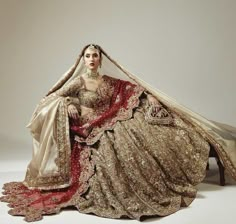 a woman in a bridal gown sitting on a chair