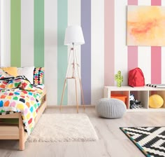 a bedroom with multicolored striped walls and white rugs on the hardwood floor