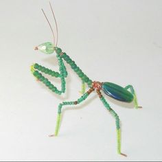 a close up of a toy insect with beads on it's body and legs