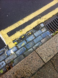 a fire hydrant sitting on the side of a road next to a yellow line