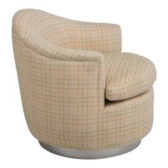 an upholstered chair with a round base