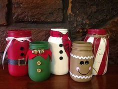 four mason jars decorated with christmas decorations