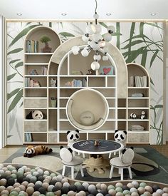 a living room with panda bears on the floor and bookshelves in the background