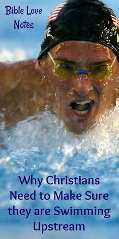 a man swimming in the water with an american flag on his cap and goggles