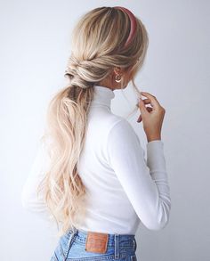 a woman with long blonde hair wearing a ponytail