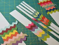 several strips of colored paper laid out on a cutting board