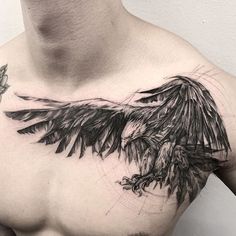 a black and white photo of a man's chest with an eagle tattoo on it