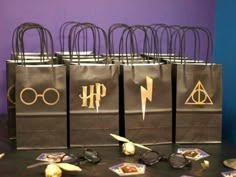 harry potter bags are on display in front of purple walls