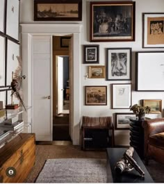 a living room filled with furniture and pictures on the wall