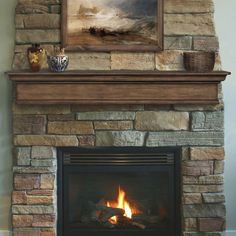 a fire place with a painting above it