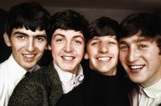 four young men are smiling for the camera