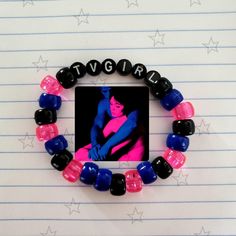 a bracelet made out of glass beads with a picture of a woman in the middle