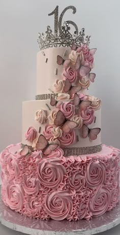 a three tiered cake with pink frosting roses and butterflies on the top layer