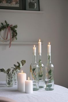 candles and bottles are sitting on a table