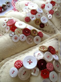 three pillows with buttons on them sitting next to each other