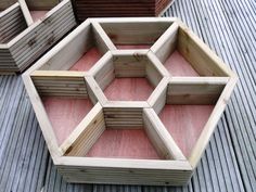 four wooden boxes sitting on top of a wooden floor next to each other with different shapes and sizes