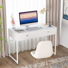 a white desk with a computer on it