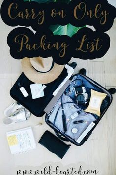 an open suitcase sitting on top of a wooden floor next to a hat and other items