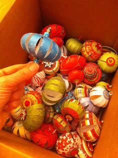 a box filled with lots of different types of ornament balls and knick knacks