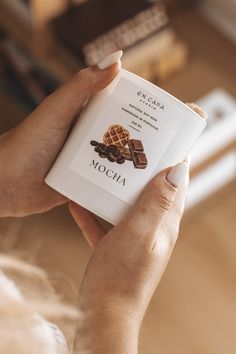 a woman is holding up a book in her hands with the title mocha written on it