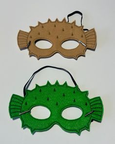 two masks that have been made to look like they are wearing green and brown colors