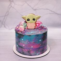 a cake decorated with an image of a baby yoda on top of the cake