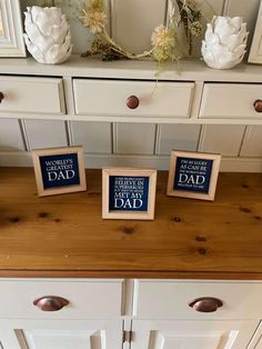 three small wooden blocks sitting on top of a dresser