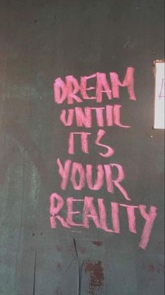 graffiti on the side of a building that says dream until it's your reality