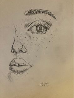 a pencil drawing of a woman's face with freckles on her eyes