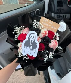 a bouquet of flowers in the front seat of a car with a ghost sticker on it