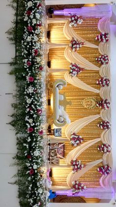 an overhead view of a wedding ceremony with flowers on the floor and decorated wall behind it