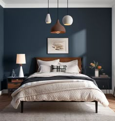 a bedroom with dark blue walls and white bedding, two lamps above the bed